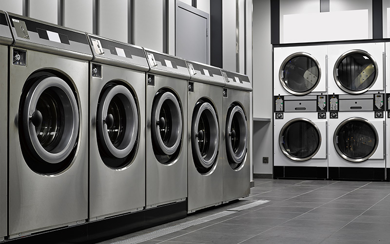 ow of industrial washing machines in a public laundromat